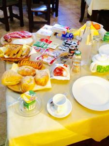 托雷圣苏桑纳费罗康蒂城堡住宿加早餐旅馆的桌上有食物和饮料,盘子