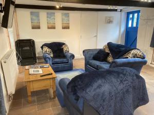 Great SalkeldThe Old Tearoom-uk32945的客厅配有2张蓝色的沙发和1张桌子
