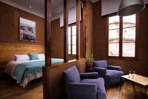瓦尔帕莱索芳纳酒店的一间卧室配有一张床、椅子和窗户。
