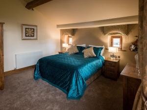 ButtershawCedar Barn - Uk33352的一间卧室配有一张带蓝色棉被的床