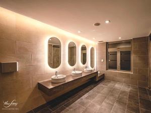 头顿Melon Home - The Sóng Apartment Vũng Tàu的浴室设有3个水槽和3面镜子