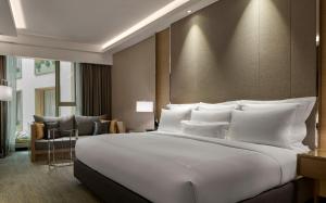 吉隆坡JW万豪酒店的一张大白色的床,位于酒店客房内