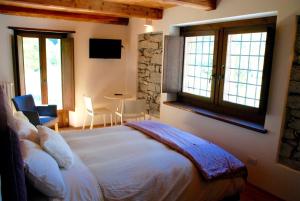 Cadarese卡德博尔格旅馆的卧室配有一张大白色床,位于带窗户的房间内