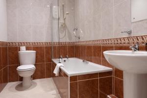 麦克尔斯菲尔德Hollin House Hotel的浴室配有卫生间、盥洗盆和淋浴。