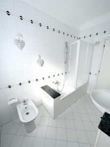 切塔尔多One More Page House - Per un soggiorno da Favola的白色的浴室设有浴缸、卫生间和水槽。