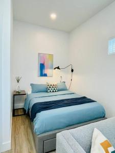 奥克兰Fully-Stocked Studio Suite Near Downtown Oakland的一间卧室配有蓝色的床和沙发
