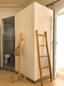 塔姆拉赫特乌兹达尔Arima Surf House的浴室设有两个木制架子和梯子