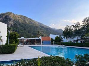 安塔利亚Magic mountain villas的一座大游泳池,后面是一座山