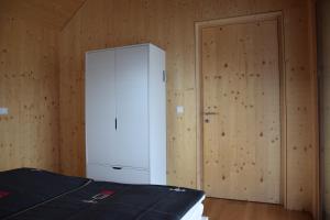 因斯布鲁克Blickfang Tirol的卧室配有白色橱柜和门