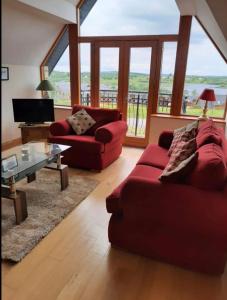 德拉姆尚博The Lake House的客厅配有红色的沙发和桌子
