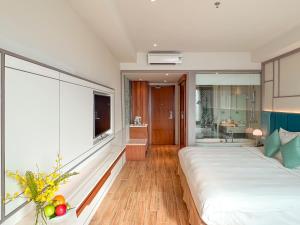 芽庄Seaesta Nha Trang Hotel的一间带大床的卧室和一间浴室