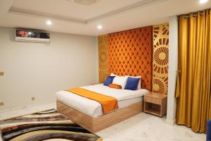 伊斯兰堡Nüva Hotel的一间卧室配有床和黄色窗帘