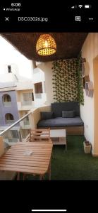 赫尔格达Binishty hurghada apartment的阳台配有沙发、桌子和灯