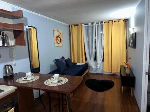 圣地亚哥Apartamentos Orquídea Suite的一个带桌子的小客厅和一间厨房