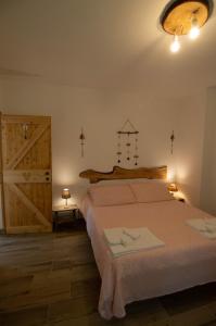 库蒂利亚诺Borgo Don Camillo的一间卧室设有一张大床和一扇木门