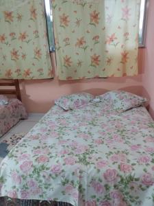 安格拉杜斯雷斯Apartamento em Chácara Aconchegante的卧室配有一张墙上鲜花的床