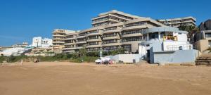 巴利托305 Ballito Manor Gardens, Ballito - With Generator的沙滩旁的海滩上建筑