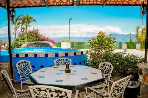 阿拉胡埃拉Loma Tranquila的一个带游泳池的庭院里的桌椅