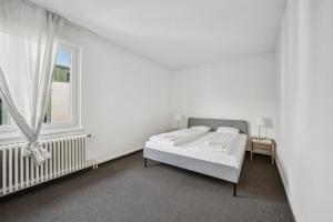 苏黎世Dohlenweg 2的白色的卧室设有床和窗户