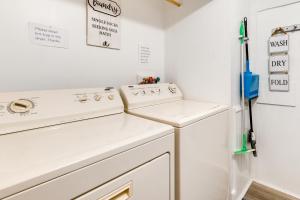 BartonCozy Vermont Escape - Patio, Lake and Mountain Views的洗衣房配有2个白色的盥洗盆和1台冰箱