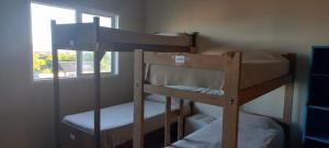 马德普拉塔La Maquinita Hostel的带窗户的客房内的两张双层床