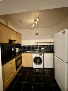 沃特福德Terrace Apartment X91 RR04的厨房配有白色冰箱和洗衣机。