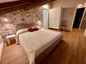 维罗纳Domus 44 Apartments的一间卧室配有一张带两个红色枕头的床