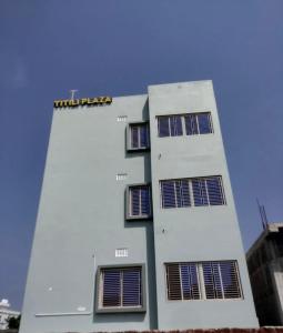 普里TITILI PLAZA的一座白色的建筑,上面有太阳能电池板