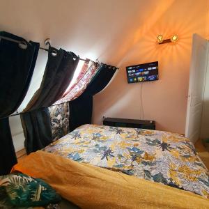 圣贝努瓦Appart Angel的一间卧室配有一张带五颜六色棉被的床