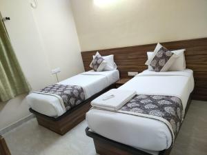 班加罗尔Hotel Bulande Comforts-1 Bedroom Flat的配有两张床的酒店客房
