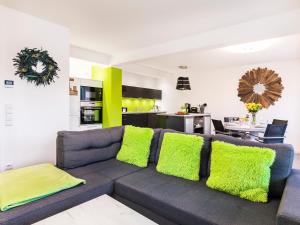 宾茨FeWo Prora - Have a nice Day的客厅配有带绿色枕头的灰色沙发