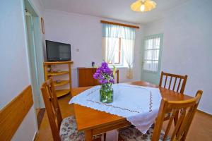 大洛希尼Apartments in Veli Losinj 14929的一张餐桌,上面有花瓶