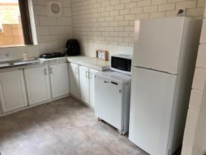 杰拉尔顿Harbour View 49 Urch Street Unit 7的厨房配有白色家电和白色冰箱