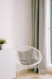 米哈斯科斯塔Casa Jilou的房间里的白色椅子和枕头