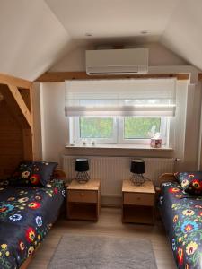 Dom ul. Otrocz Nowy 1的小房间设有两张床和窗户