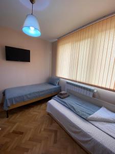 特尔戈维什特Luxury Apartment near Varna, located in Targovishte的客房设有两张床和一台平面电视。