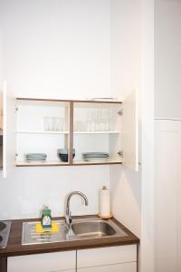 维也纳Premium 80 m2 Apartment - 5 min to Center - Free Parking的厨房配有白色橱柜和水槽