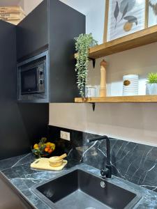 瓦伦西亚Bear Homes - Olimpia Suite的厨房柜台设有水槽和微波炉