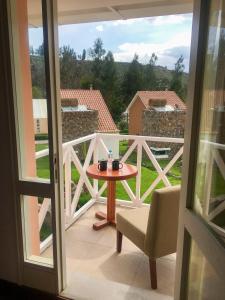 Coporaque阿兰瓦普鲁布里托恩坎塔德尔科尔卡酒店的阳台配有桌椅,享有风景。