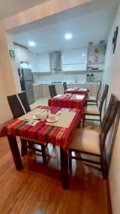 普诺MADA Guest House Puno "Hospedaje"的一间带桌椅的用餐室和一间厨房