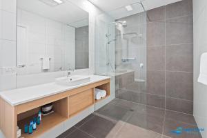 莫鲁亚Hive Hotel, Moruya的白色的浴室设有水槽和淋浴。