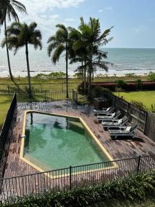 Newell BeachABSOLUTE BEACHFRONT BLISS - NEWELL BEACH - 10 Metres to the Ocean的一个带躺椅的游泳池和海滩