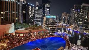 迪拜Luxury Address Res DubaiMarina Studio1 Frank&Frank的享有夜间城市美景,设有游泳池