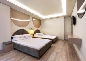 伊斯坦布尔Park Çağlayan Hotel的配有电视的酒店客房内的两张床