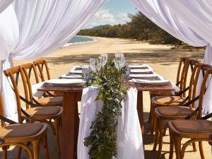 棕榈湾铂尔曼棕榈湾海神庙度假酒店&水疗中心的一张在海滩上为婚礼准备的桌子