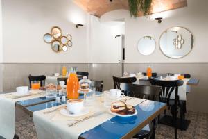 罗马Hotel La Ville Rome的用餐室配有桌椅和食物