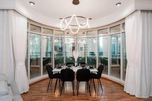迪拜Spacious 2BR apartment in Marina Crown的一间带桌椅和吊灯的用餐室