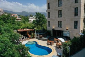 朱尼耶Heaven Prestige Hotel的享有酒店上方的游泳池景致