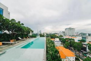胡志明市Serenity Saigon Sky Villas的从带游泳池的建筑屋顶上欣赏美景