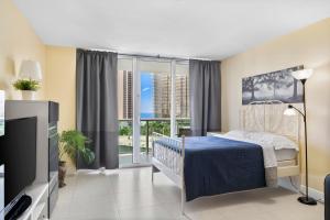 迈阿密海滩OCEAN RESERVE APARTMENt的一间卧室设有一张床、一台电视和窗户。